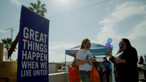 Two United Way Fresno and Madera Counties staff members talking at an outdoor event.